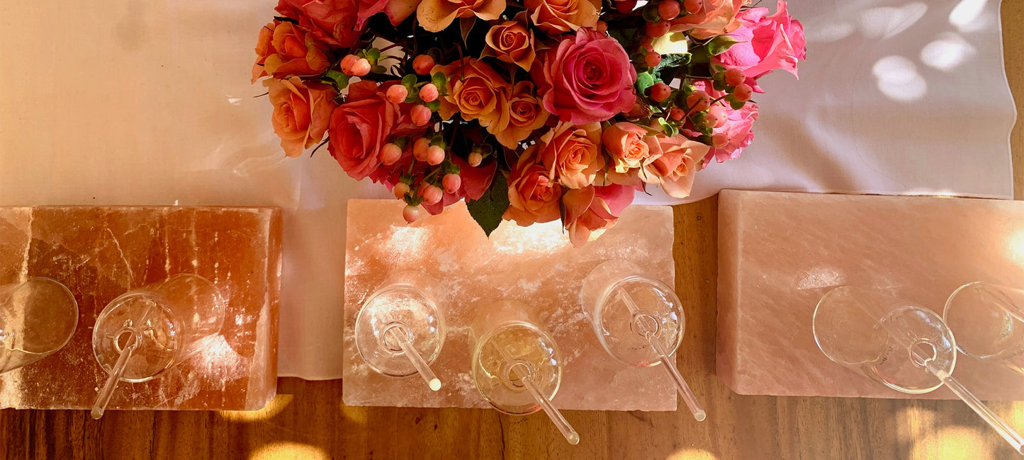 photo looking down at table with flower bouquet and clear bottles of fragrance oils